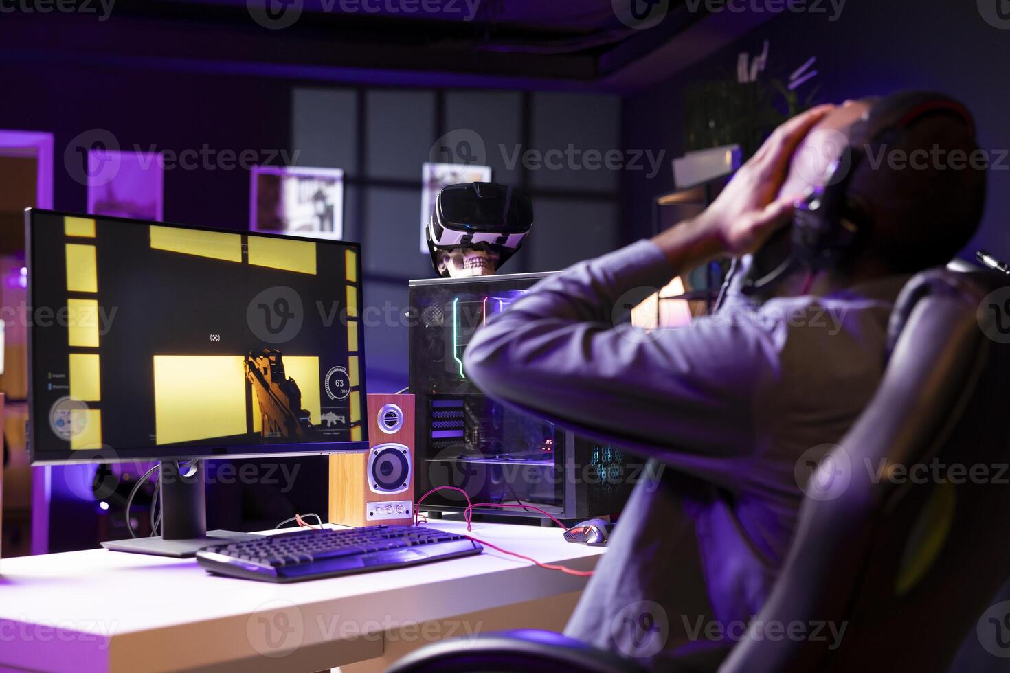 Gamer upset after losing while playing FPS cyberspace videogames on PC monitor. Man putting face in hands in frustration after being defeated playing online games on computer at desk photo