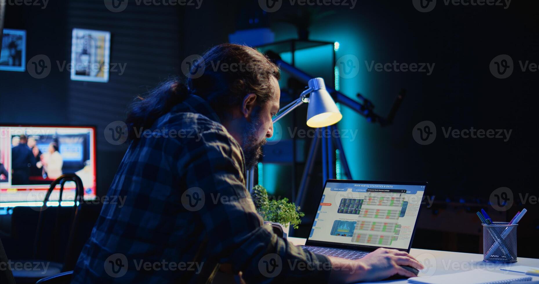 Self employed man checking statistical data financial graphs on laptop screen, researching insights. Remote worker comparing business graphic economic figures, making strategy, camera B photo