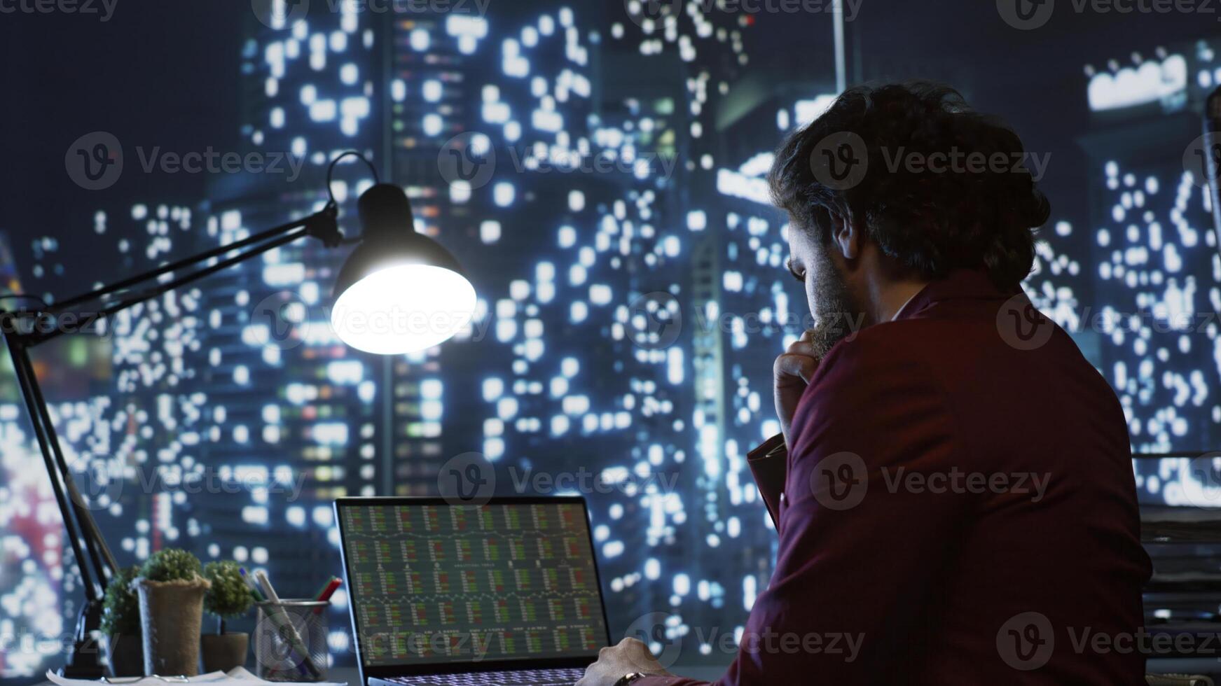 Rich stockbroker examining international market trends, looking to sell financial securities and increase global company revenue. Professional investor working at night, provides necessary liquidity. photo