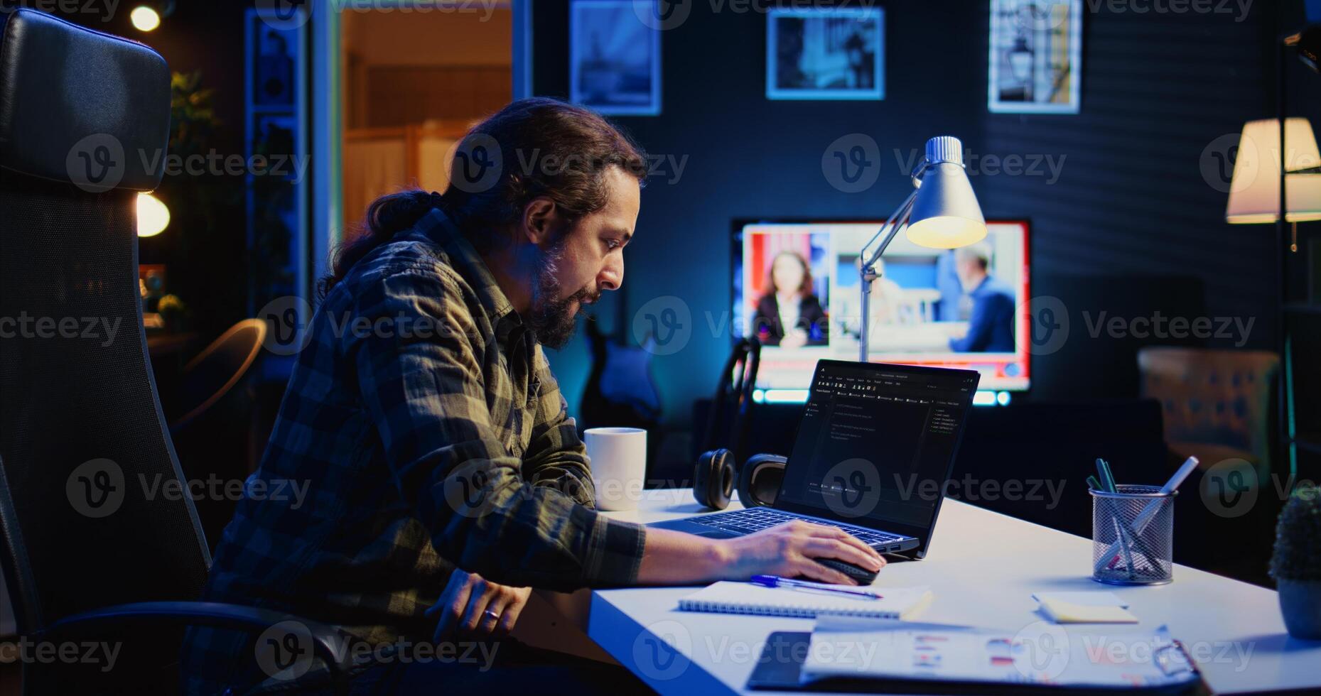 Skilled computer scientist writes code on laptop screen while in living room office using programming languages. Self employed IT specialist working on fixing database errors from home, camera B photo