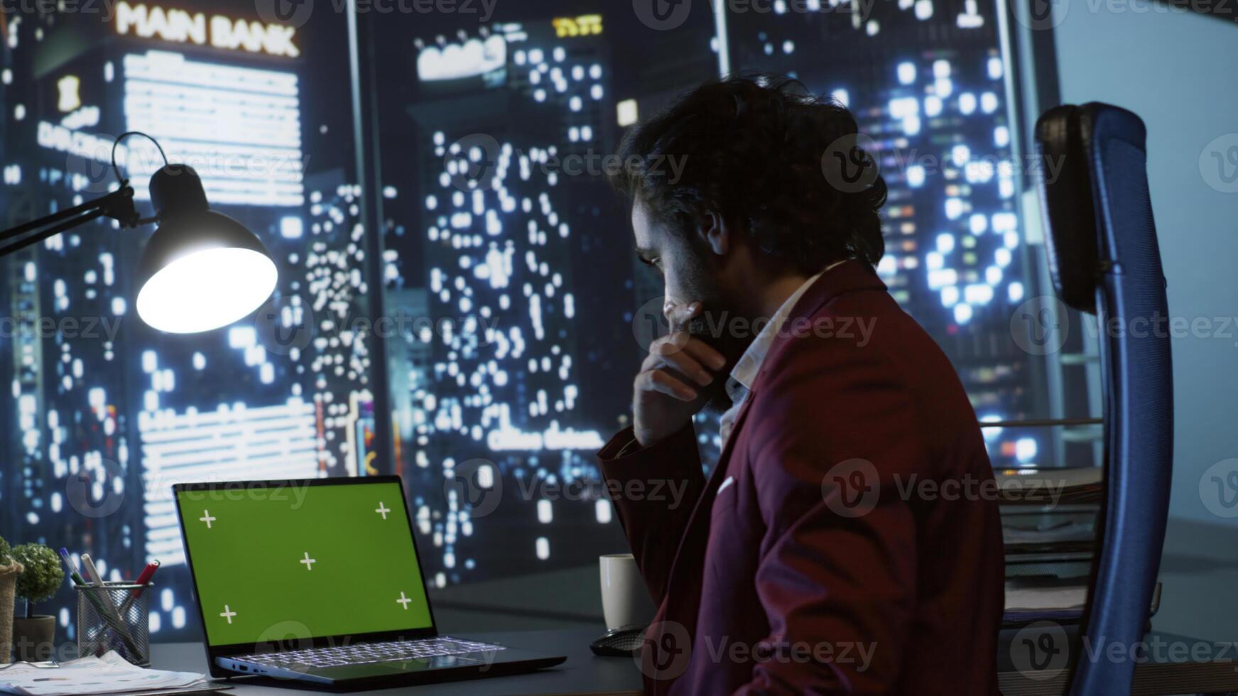 Legal investor works with greenscreen on pc at workstation, examining isolated chromakey display from panoramic view office. Chief executive director working at night with copyspace template. photo