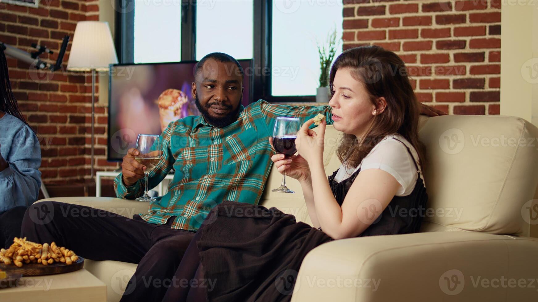 Company employees celebrating business success at work, gathered at home to toast wine drinks for their accomplishments, throwing house party in stylish living room photo