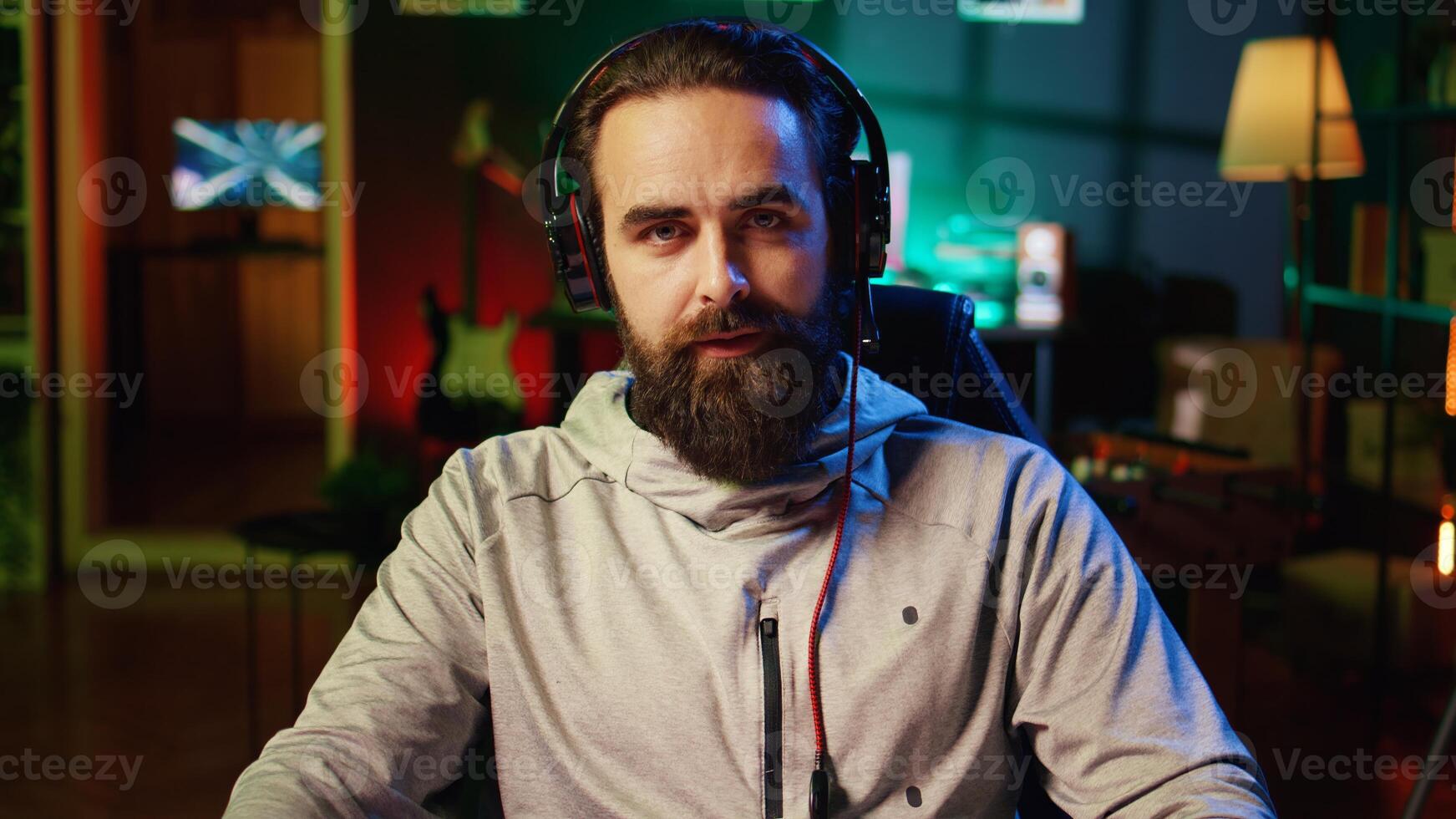 Streamer greeting audience, filming tutorial on how to defeat enemies in multiplayer game, zoom out shot. Close up on professional gamer playing videogame, teaching fans esports strategies photo