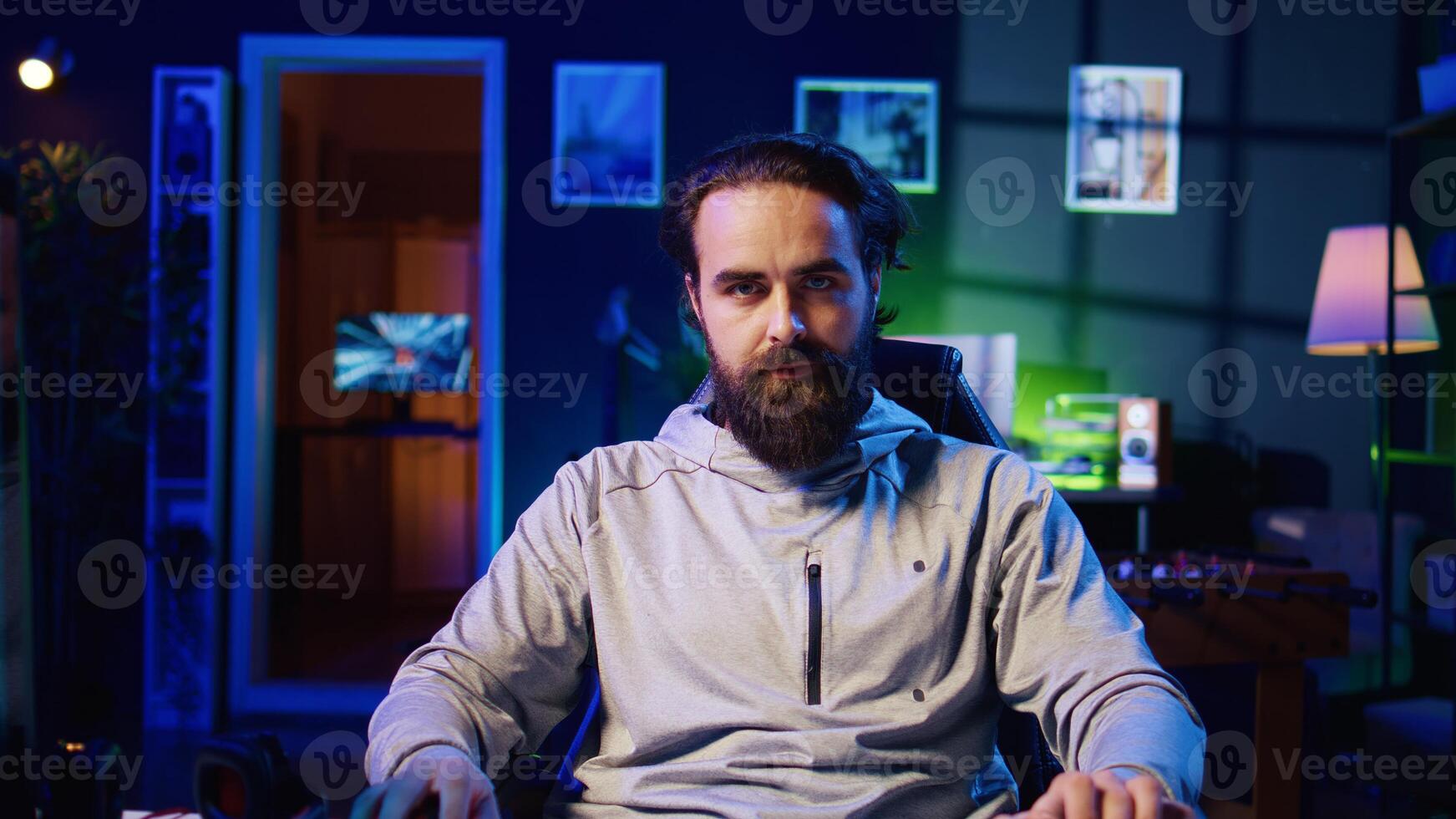Professional gamer engaging in online competitive multiplayer match using cutting edge gaming setup. Zoom in close up on man at home captivating spectators during live broadcast, playing videogames photo