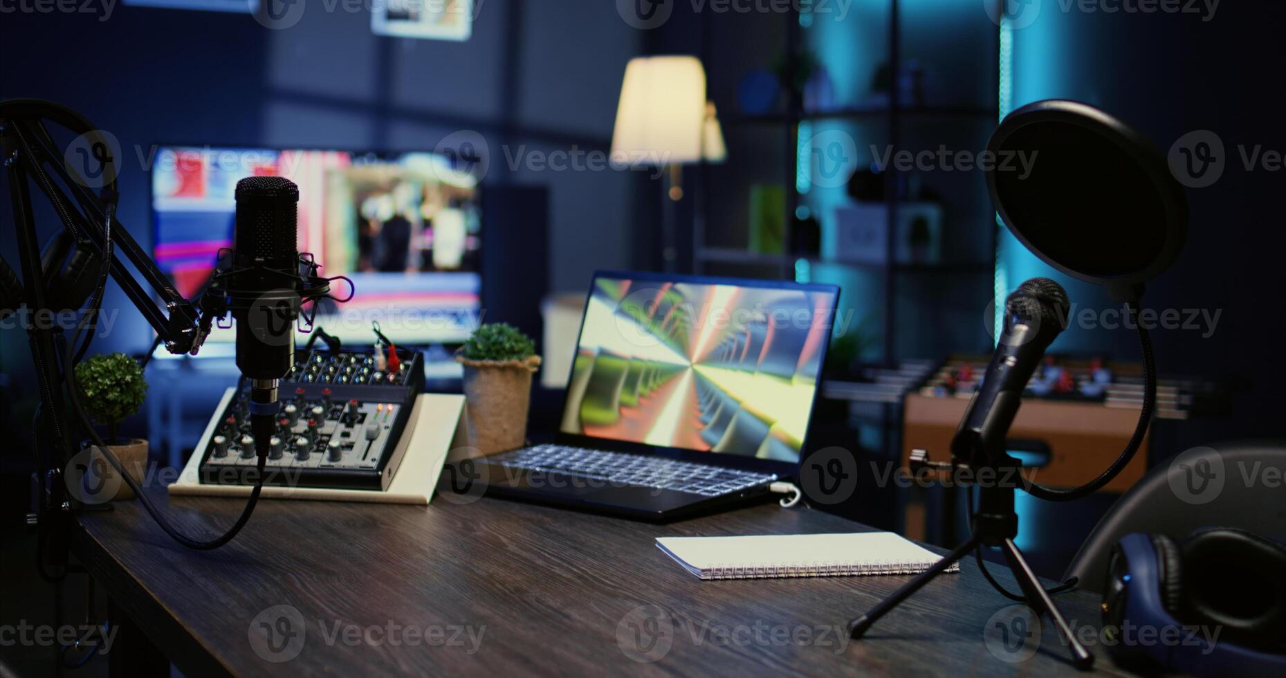 Jib down shot of wooden desk in studio with podcast gear technology recording sound for social media channel production. Live broadcasting space with specialized tech in dimly lit apartment photo