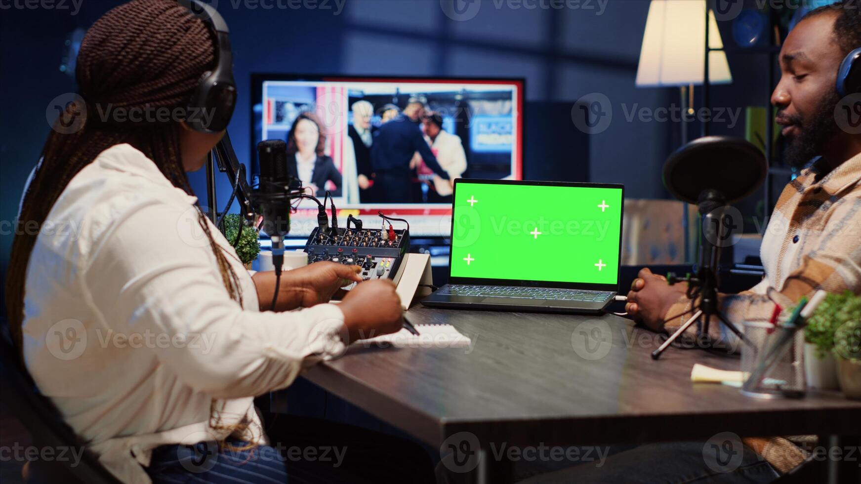 Isolated screen laptop on desk next to presenter on podcast chatting with guest during marathon stream for humanitarian cause. Chroma key notebook used by host to check gathered donations from fans photo