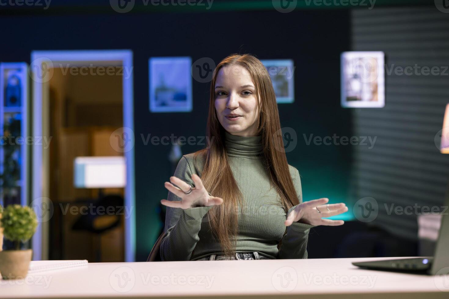 Cheerful girl filming herself discussing topics of interest for generation Z fanbase watching her online social media content. Upbeat media star recording targeting gen Z viewers photo