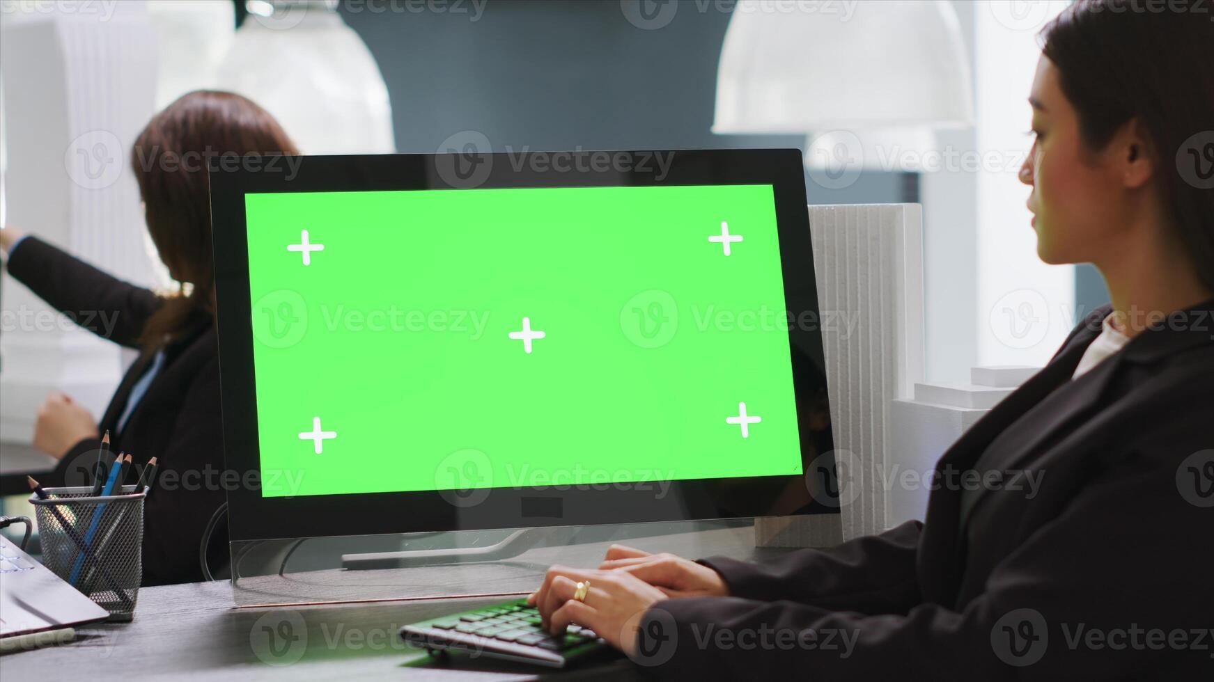 Cad designer using PC with greenscreen at workstation area, examining monitor with blank copyspace design in startup company. Engineer uses isolated chromakey display on computer. photo