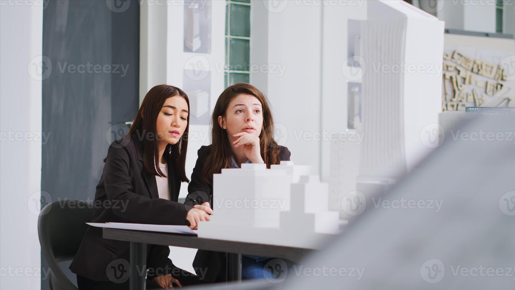 Technicians drawing lines on construction plans draft after reviewing 3d maquette model, translating measurements. Designers working on residential development project, real estate agency. photo