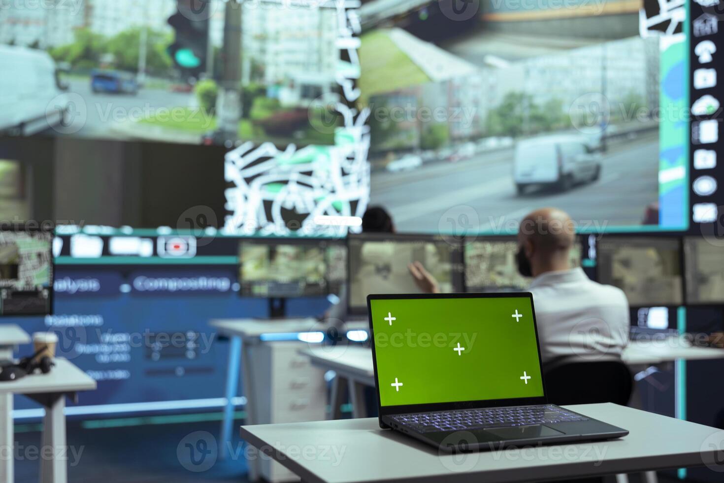Diverse employees monitoring delivery trucks routes with an isolated screen laptop, following alternative routes on satellite map and radar. Diverse people work on order tracking. photo