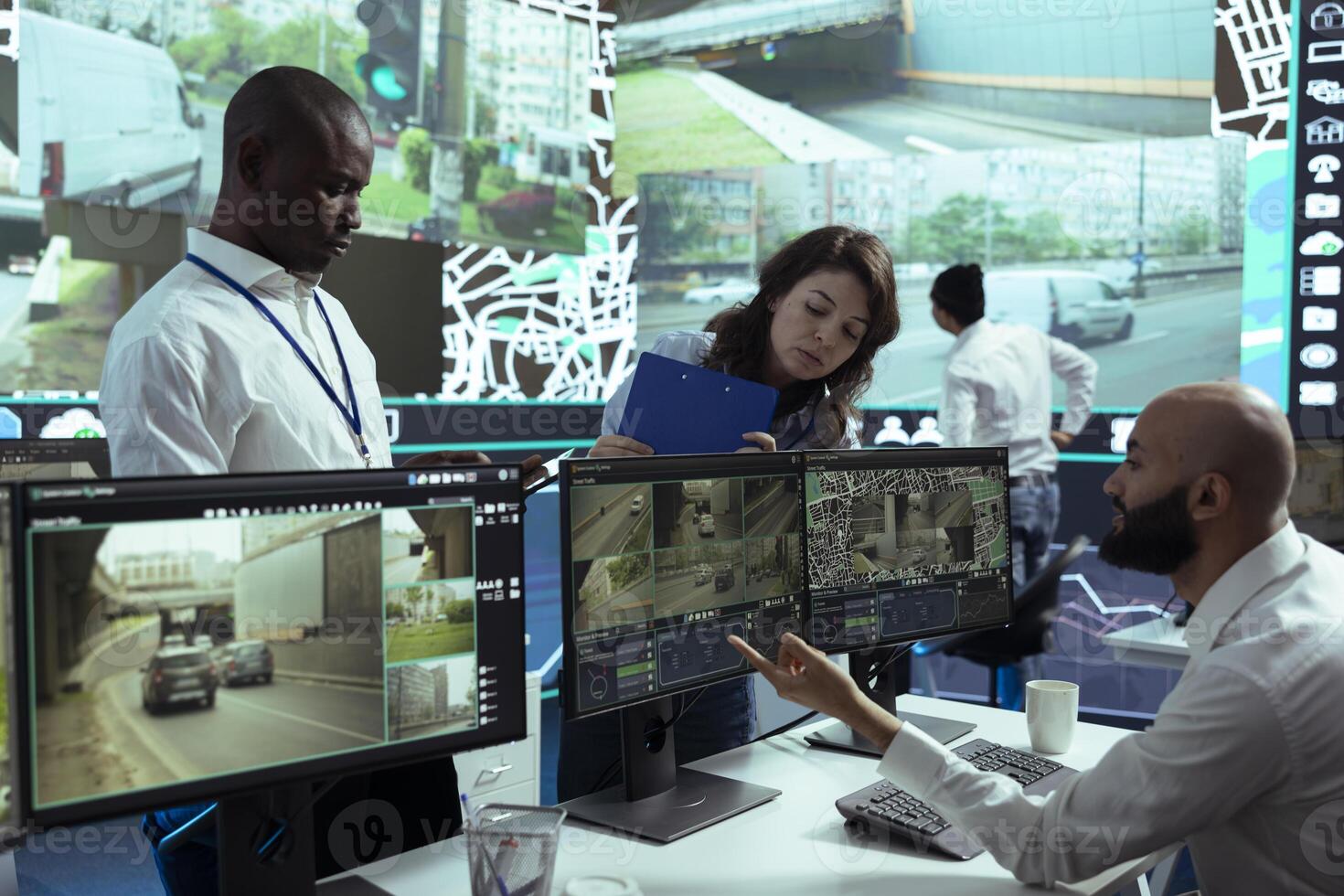 Diverse team of supervisors overseeing their staff activity on gps locating, following delivery truck drivers around in traffic via satellite map. Operators guiding couriers on routes. photo