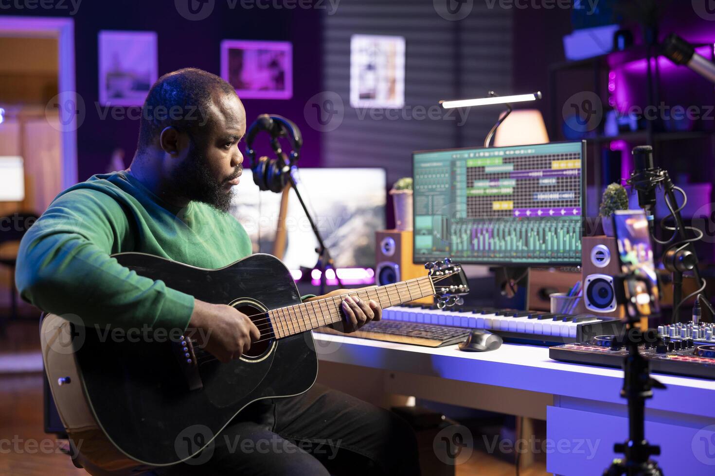 Talented performer teaching how to play acoustic guitar online for a tutorial, hosting internet master class lessons to provide advice for beginners. Artist composer explaining accords on strings. photo