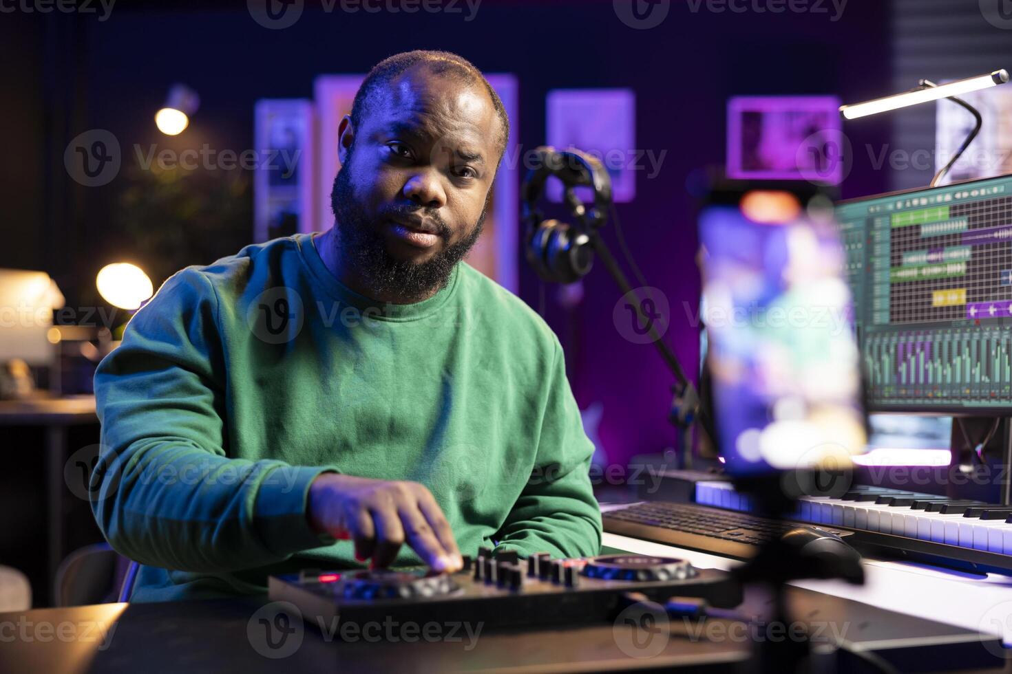 Audio technician teaching people to operate a mixing console during online master class, recording a with important post production explanations. Producer hosting music editing lessons. photo