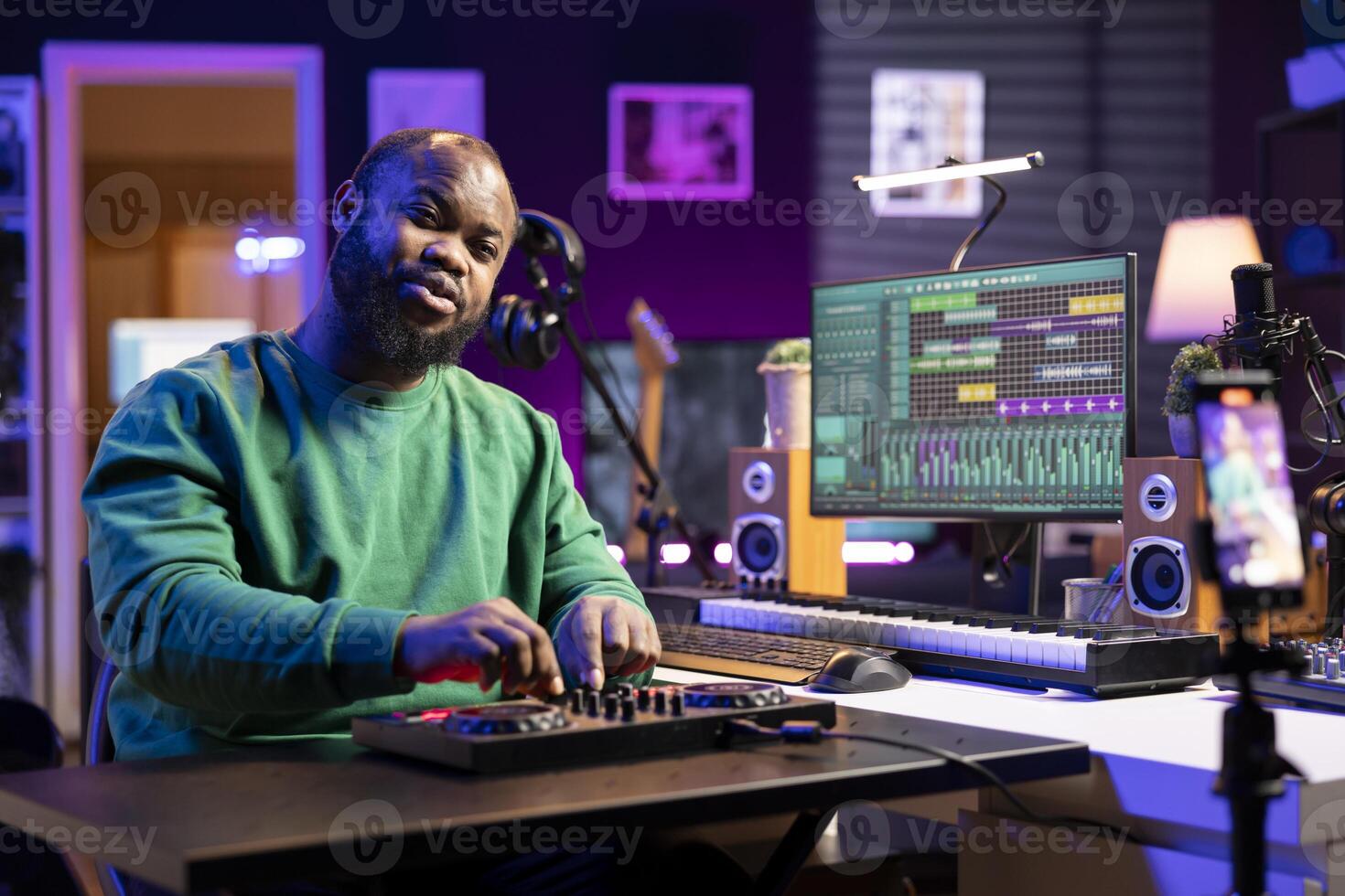 Audio technician hosting a master class lesson on internet to teach mixing and mastering techniques, online vlog. Music producer and engineer explains knobs and buttons on a stereo console. photo