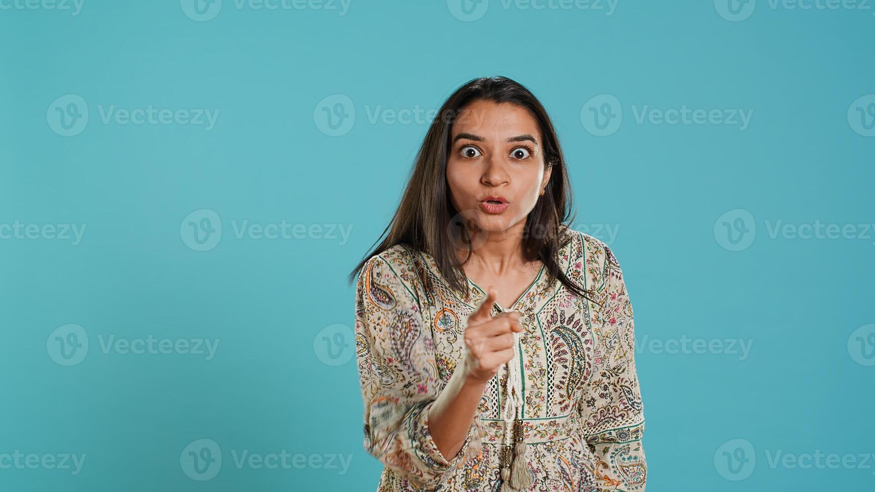 Upset indian person fighting with friend, doing scolding gesturing, isolated over studio backdrop. Annoyed woman arguing with opponent during discussion, doing admonishing hand gestures, camera A photo