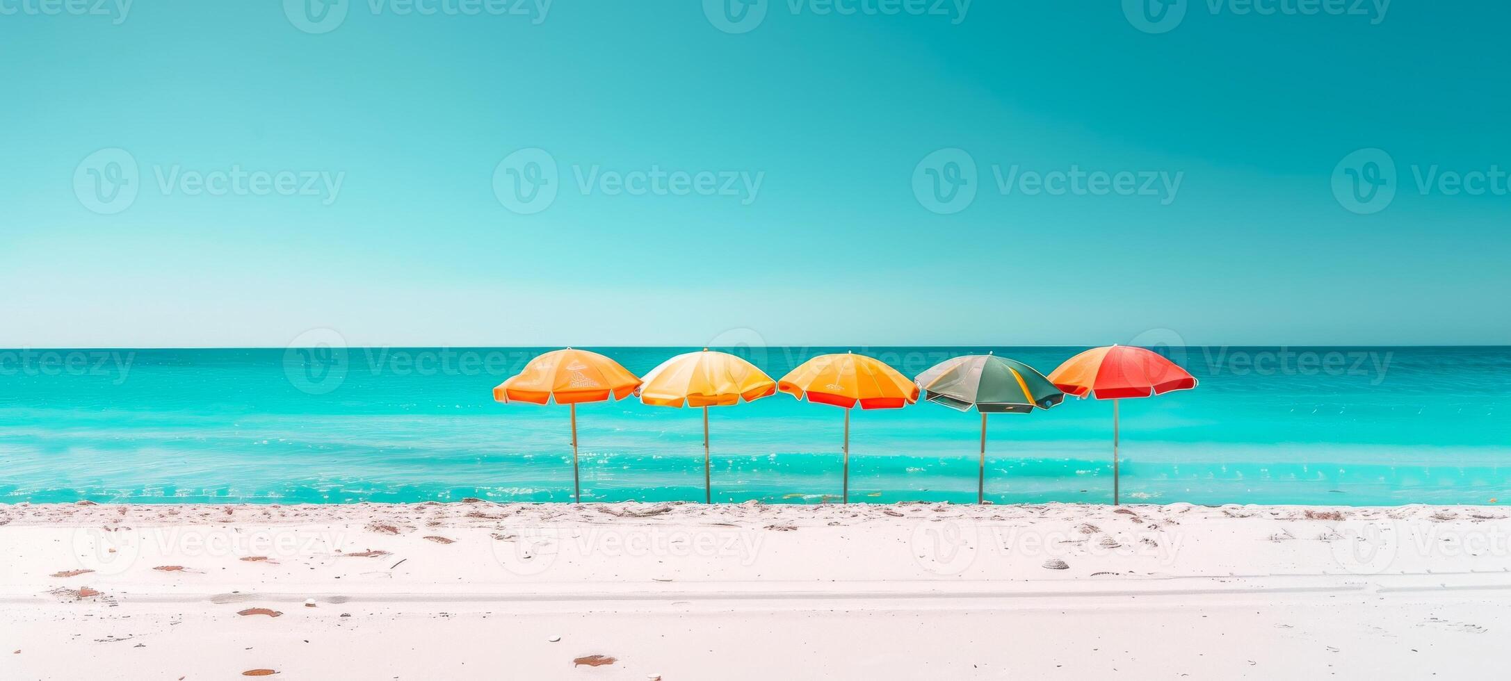 Colorful beach umbrellas lined up on a sandy beach with clear blue skies and bright sunlight. Concept of beach resort, summer vacation, sun protection, and leisure. Banner. Space for text photo
