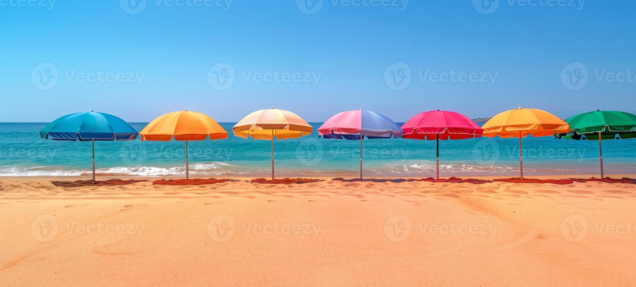 Vibrant umbrellas along coastal landscape. Row of colorful umbrellas on beach. Concept of sunshade, seaside leisure, family vacation, and tourist spot. Banner. Space for text photo
