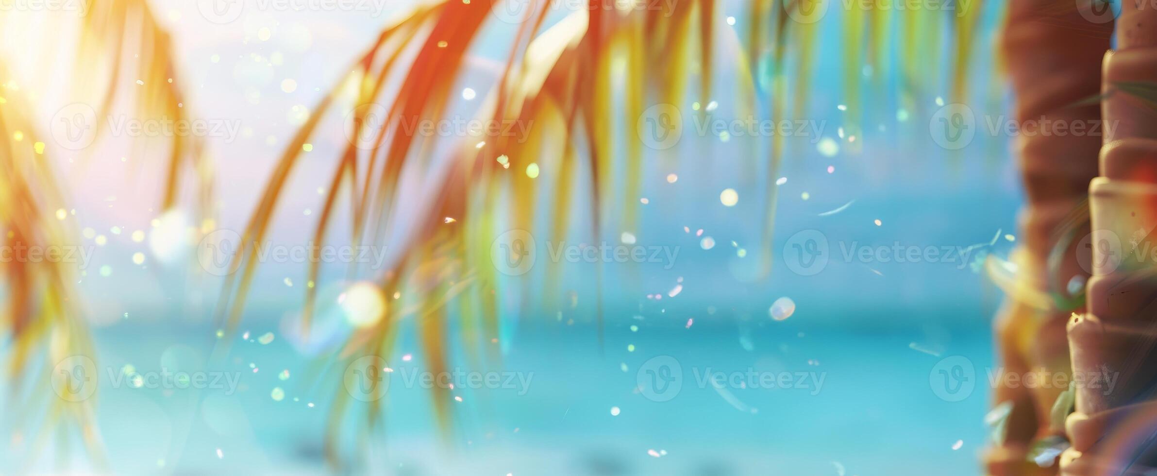 Bright tropical background with palm leaves, ocean with bokeh effect on sunny day. Vivid foliage under sunlight. Concept of summer vibe, nature's beauty, vacation. Wide tropical banner. Space for text photo