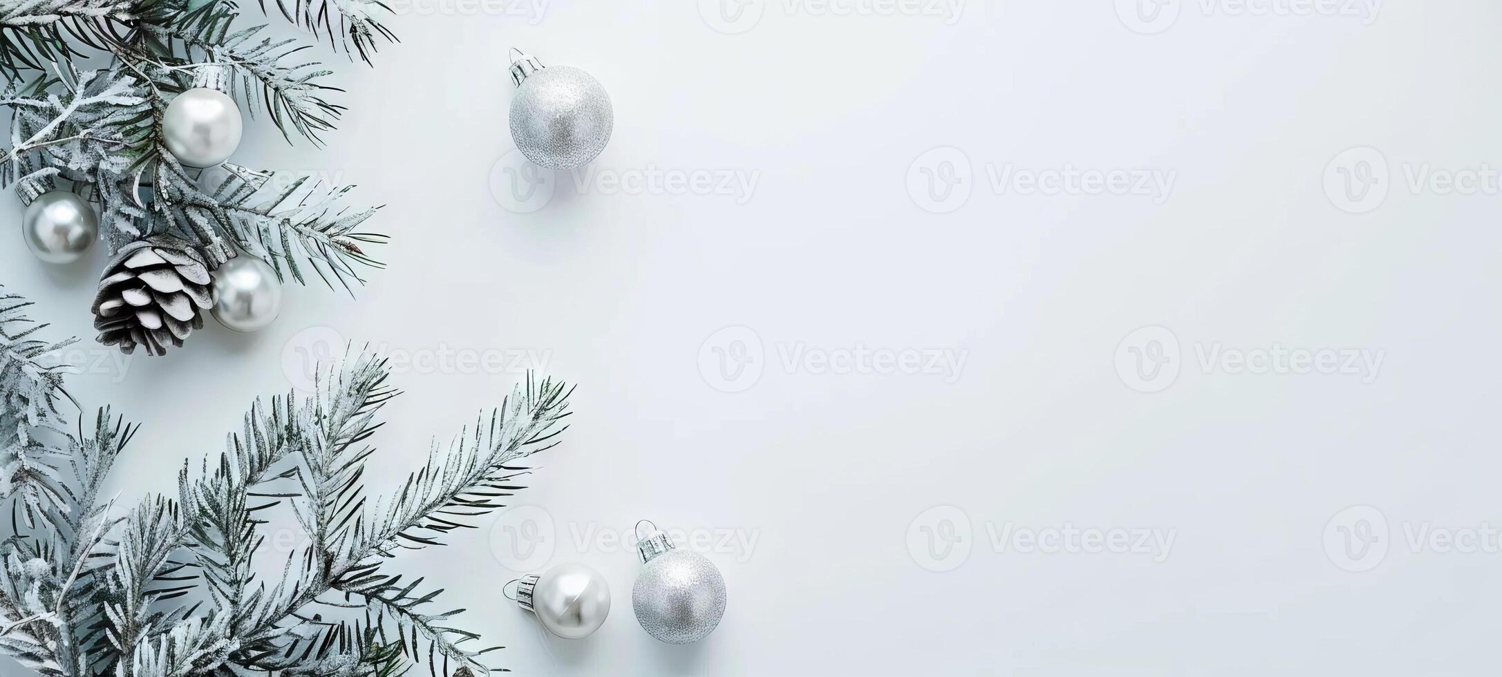 Sparkling silver Christmas ornaments with pine branches and pine cones on a white background. Concept of holiday decoration, festive season, winter celebration, Christmas design. Banner. Copy space photo