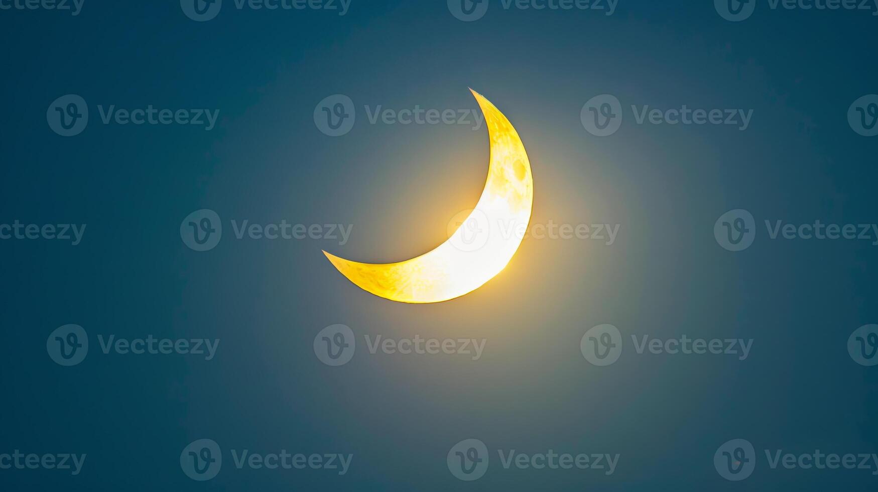 Dark sky with a bright crescent sun in a partial solar eclipse. Concept of solar eclipse, sky phenomenon, astronomy event, and natural spectacle photo
