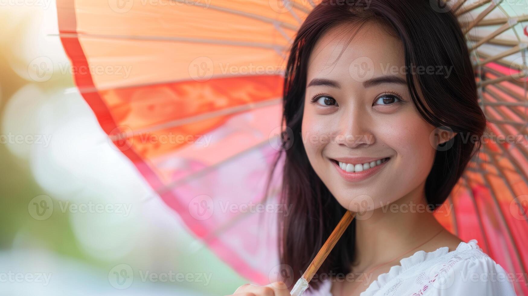 Asian woman with traditional parasol. Beautiful lady outdoors with umbrella. Concept of culture, beauty, elegance, nature. Copy space photo