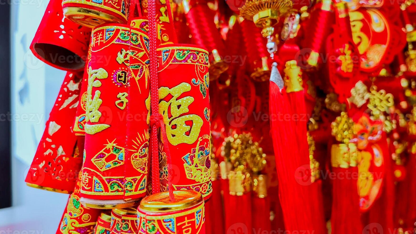 Vibrant red and gold traditional Chinese New Year decorations, featuring firecrackers and hanging ornaments, symbolize prosperity and happiness photo