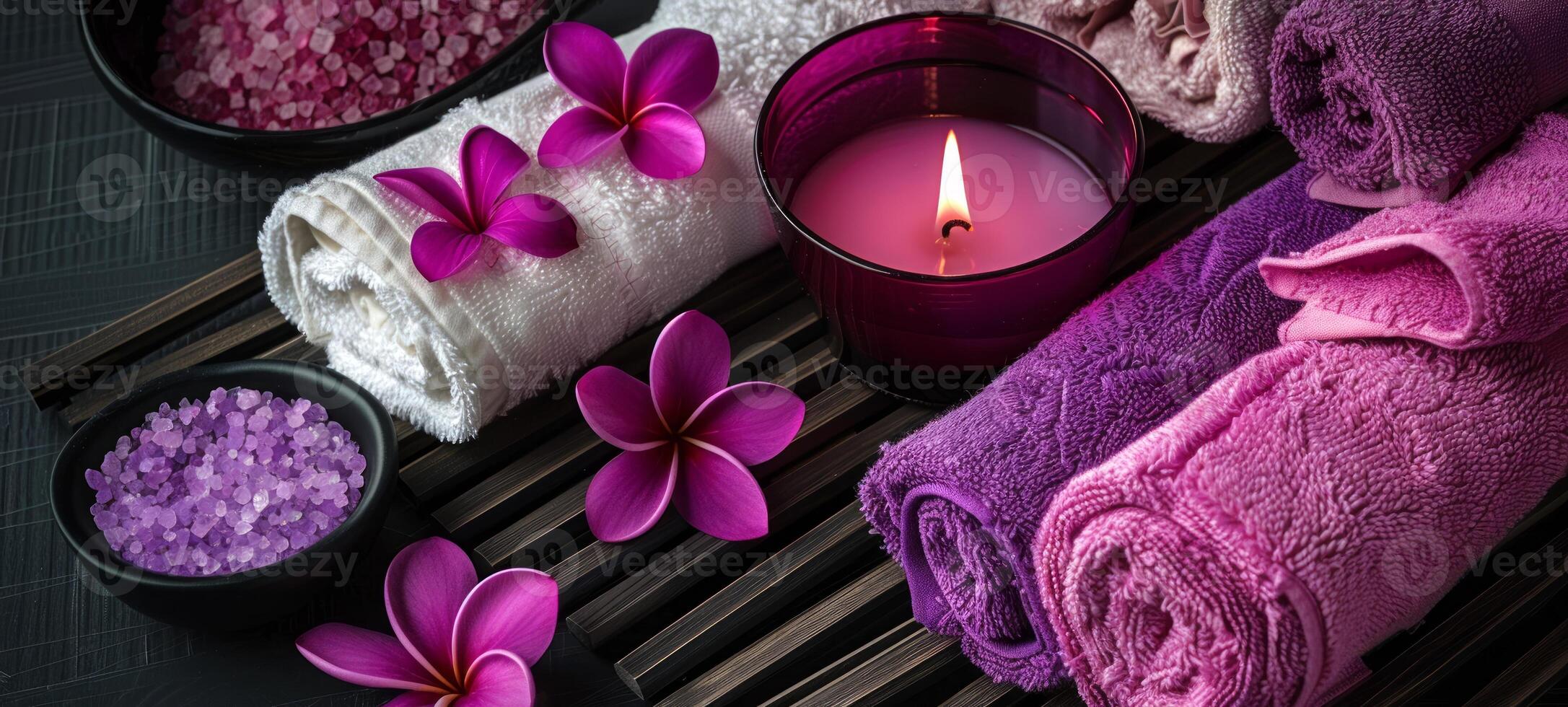 Decorative spa setting with purple towels and candles. Luxurious spa ambiance with floral elements. Concept of indulgence, tranquility, relaxation space, and elegant design. photo