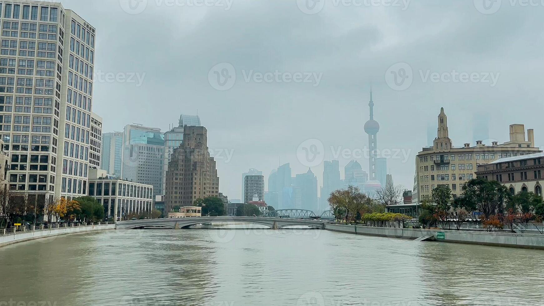Foggy cityscape of Shanghai with the iconic Oriental Pearl Tower in the distance, reflecting modern urban architecture and travel in China photo