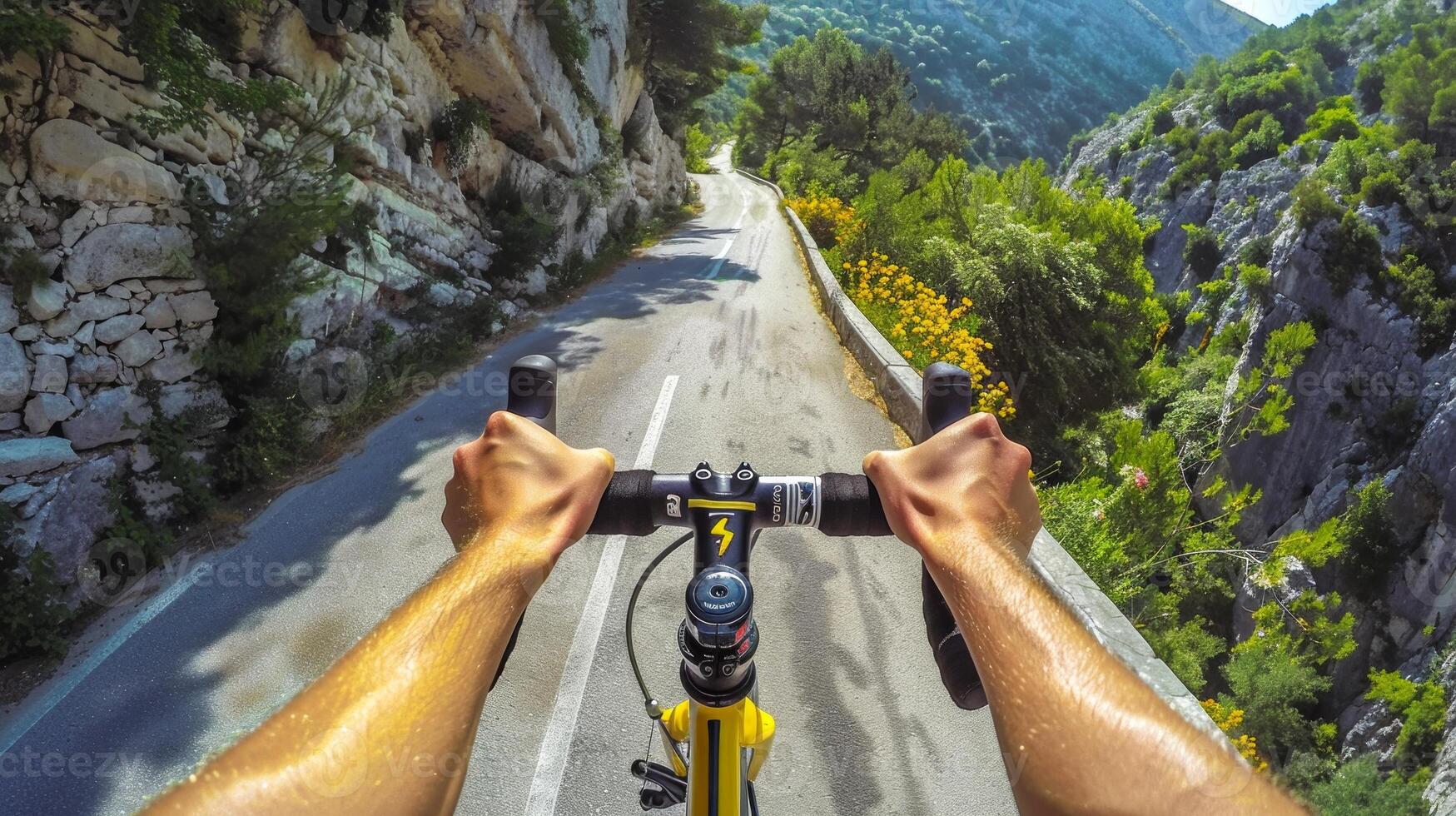 Cyclist riding on a mountain road. Hands grip the handlebars as the bike travels through scenic hills. Concept of adventure, cycling, outdoor activity, nature photo