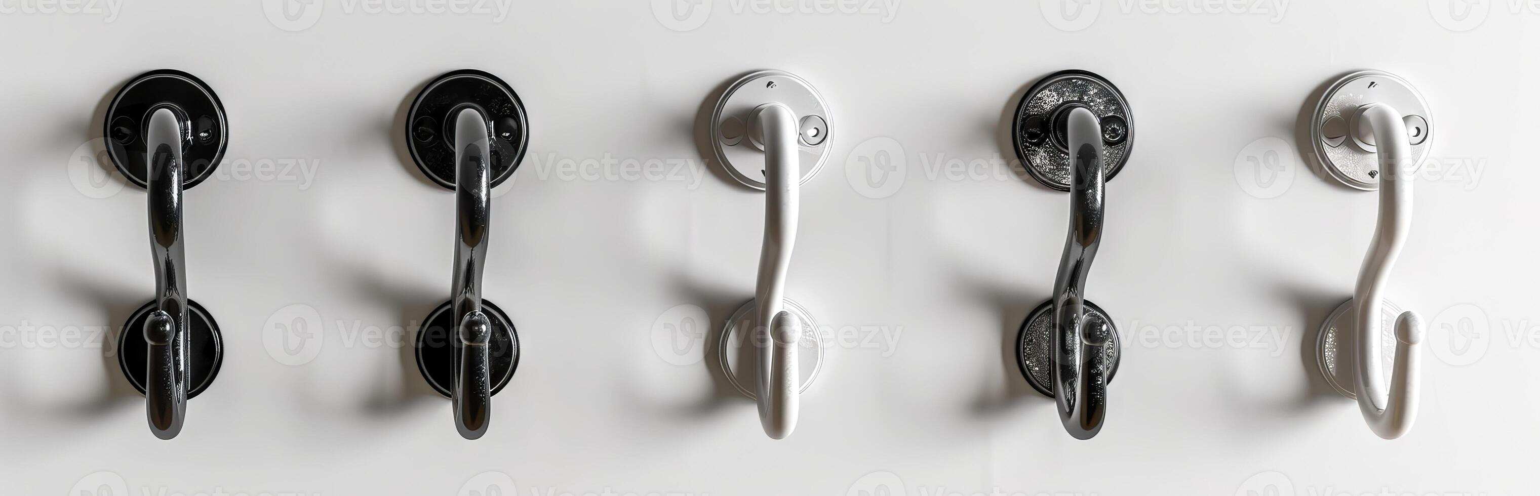 Five black metal hooks on a white background. Series of wall hooks. Concept of organization, utility, order, home decor photo