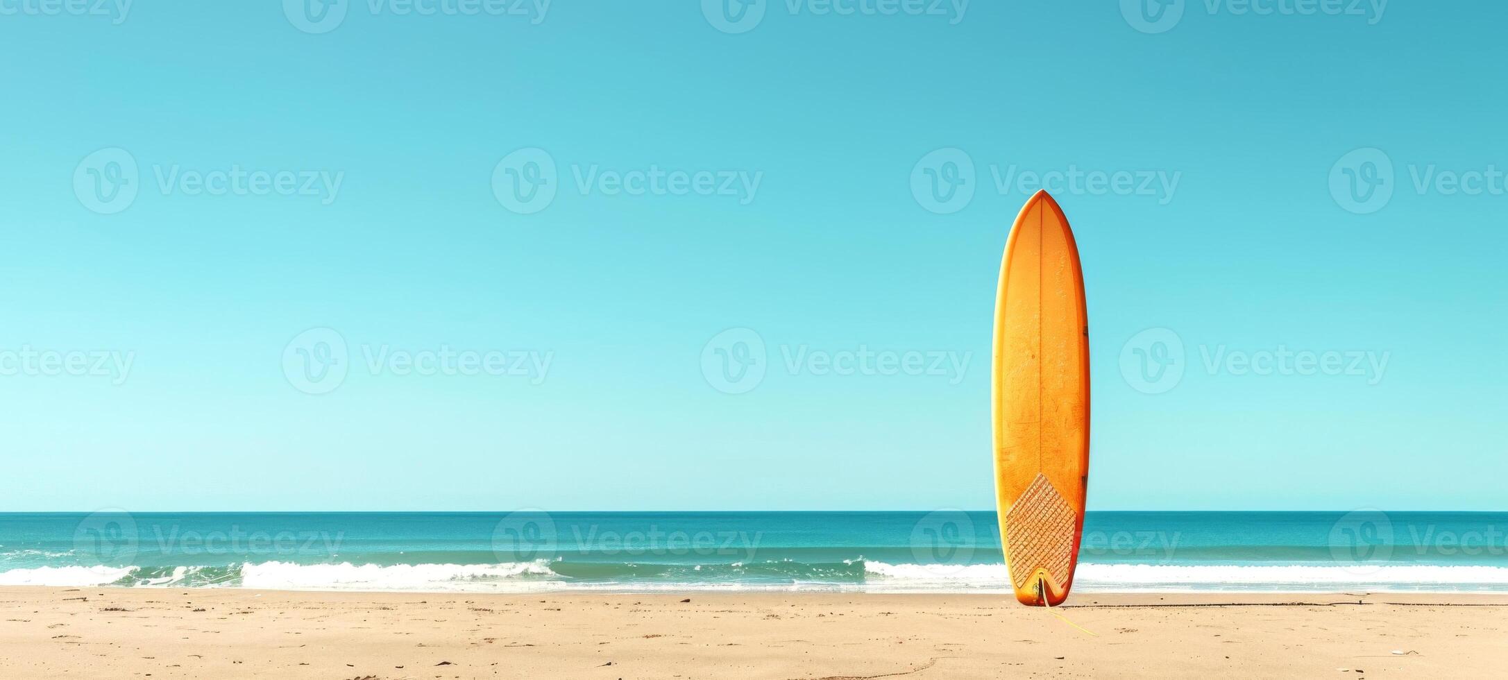 Surfboard erect on sandy beach under clear sky. Beachside surfboard. Concept of leisure sports, surf culture, coastal recreation, and sunny beach days. Copy space. Banner photo