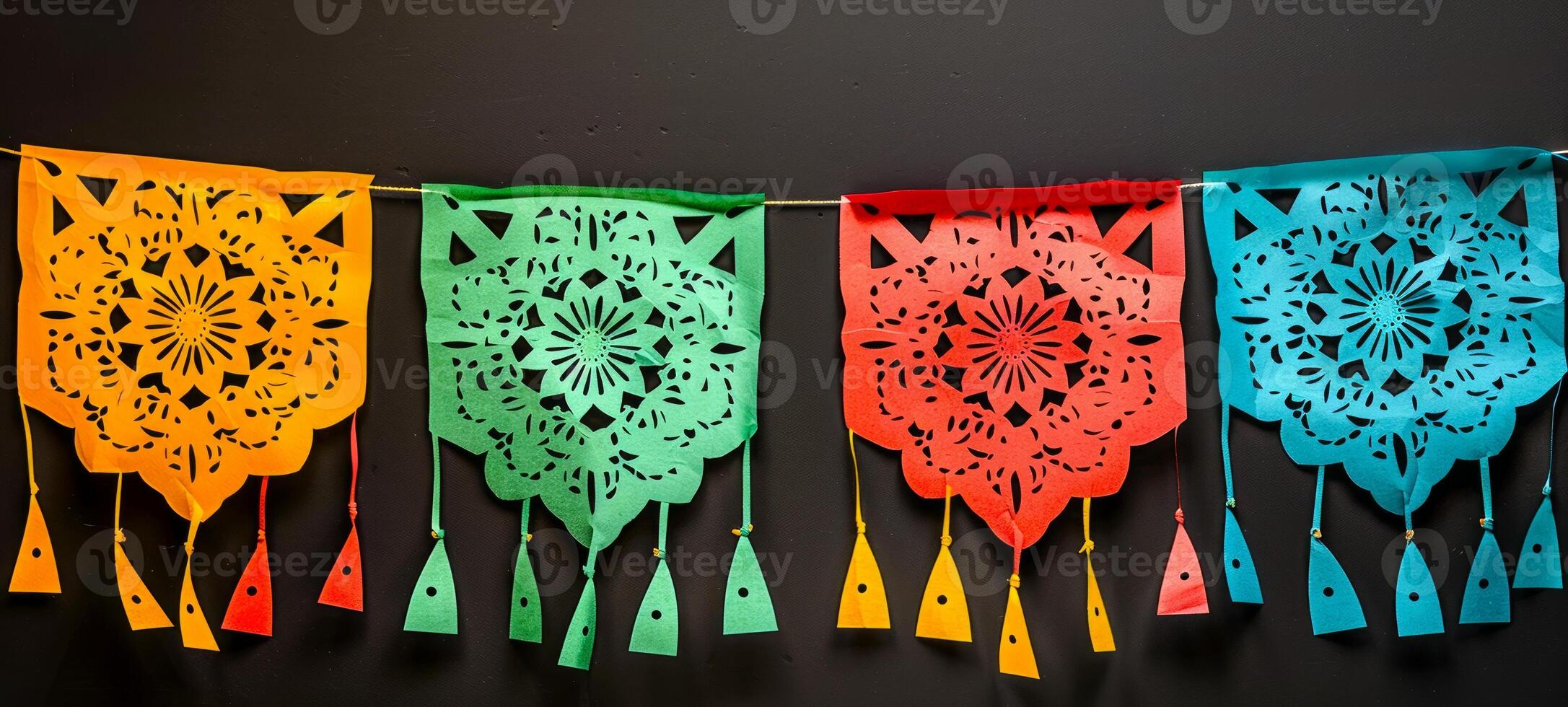 Colorful papel picado banners on a dark background. Vibrant Mexican cut-out decorations. Concept of celebration, festive design, Day of the Dead, Dia de los Muertos. Mexican party decoration photo