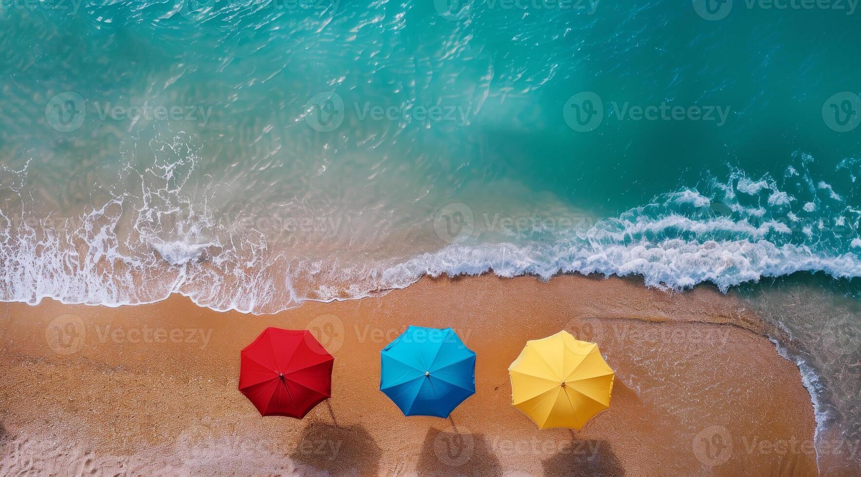 Colorful Beach Umbrellas on Sandy Shore with Ocean Waves photo