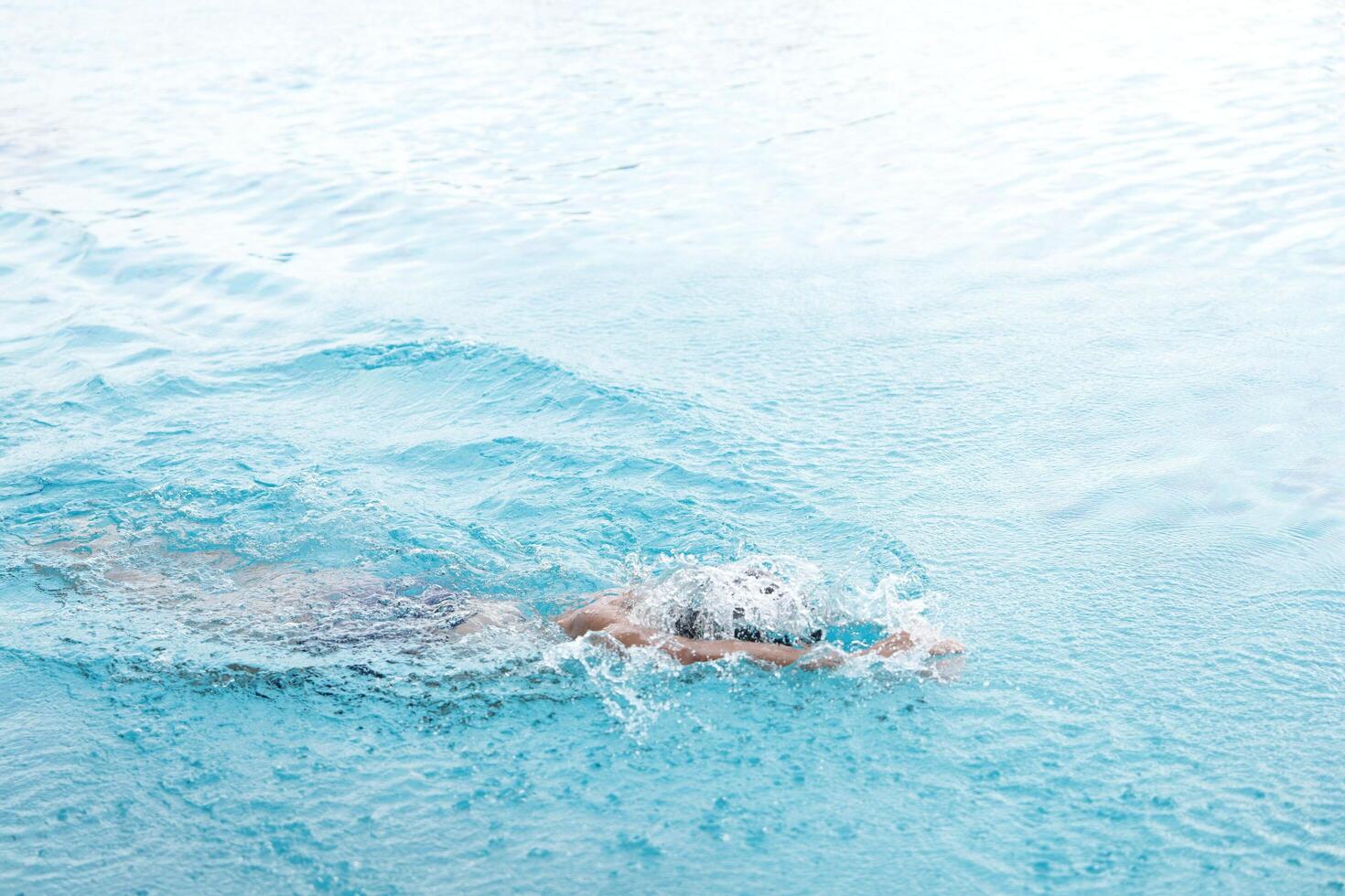 Asian men practicing swimming and preparing to play water polo and stretching and resting for water sports. photo