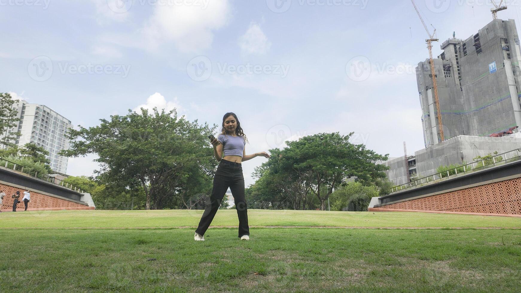 Asian women do freestyle hip hop and breakdancing in a public space in the middle of the city. With a cheerful and happy attitude photo