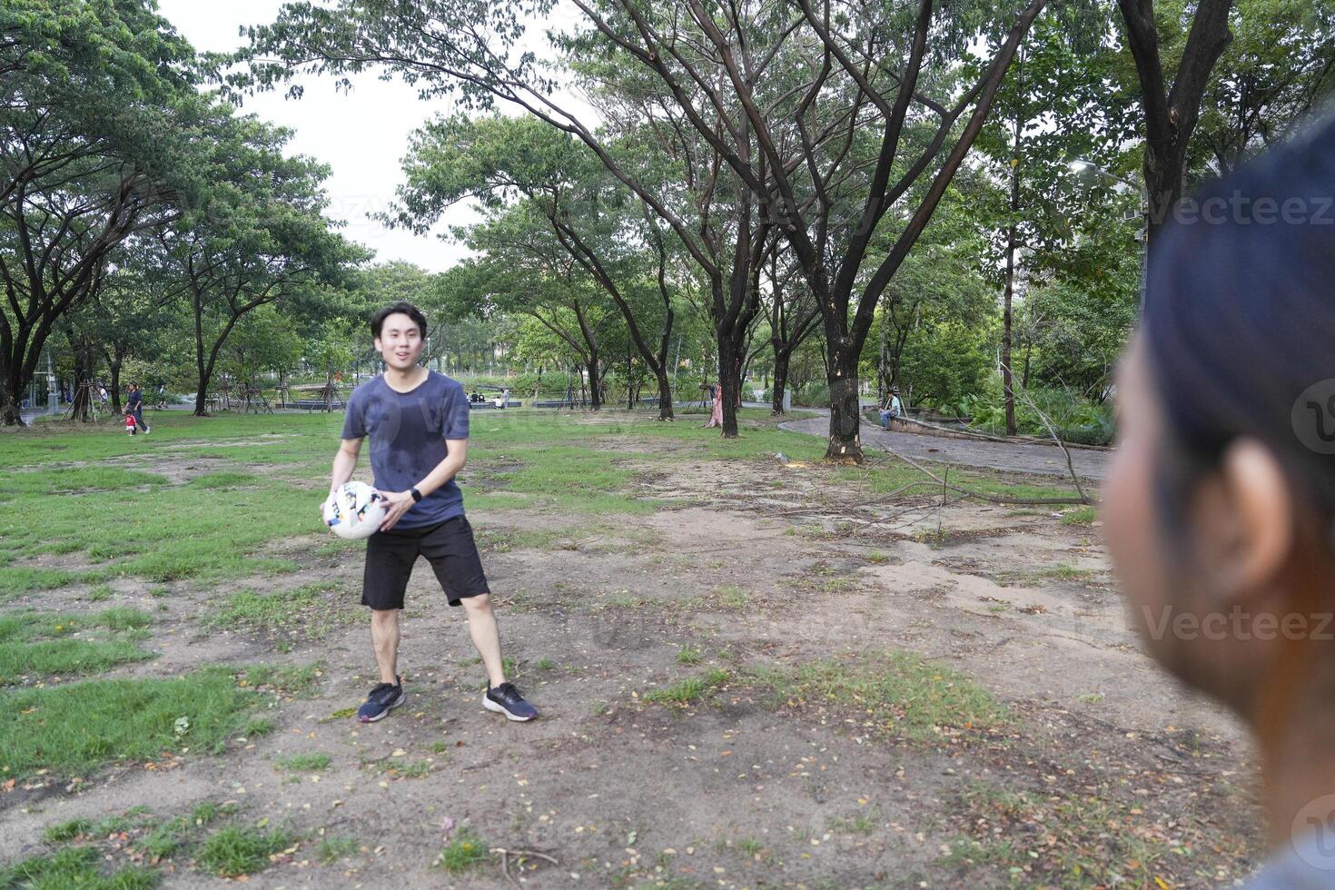 Male and female soccer players practice using the ball in the park field diligently and happily. photo