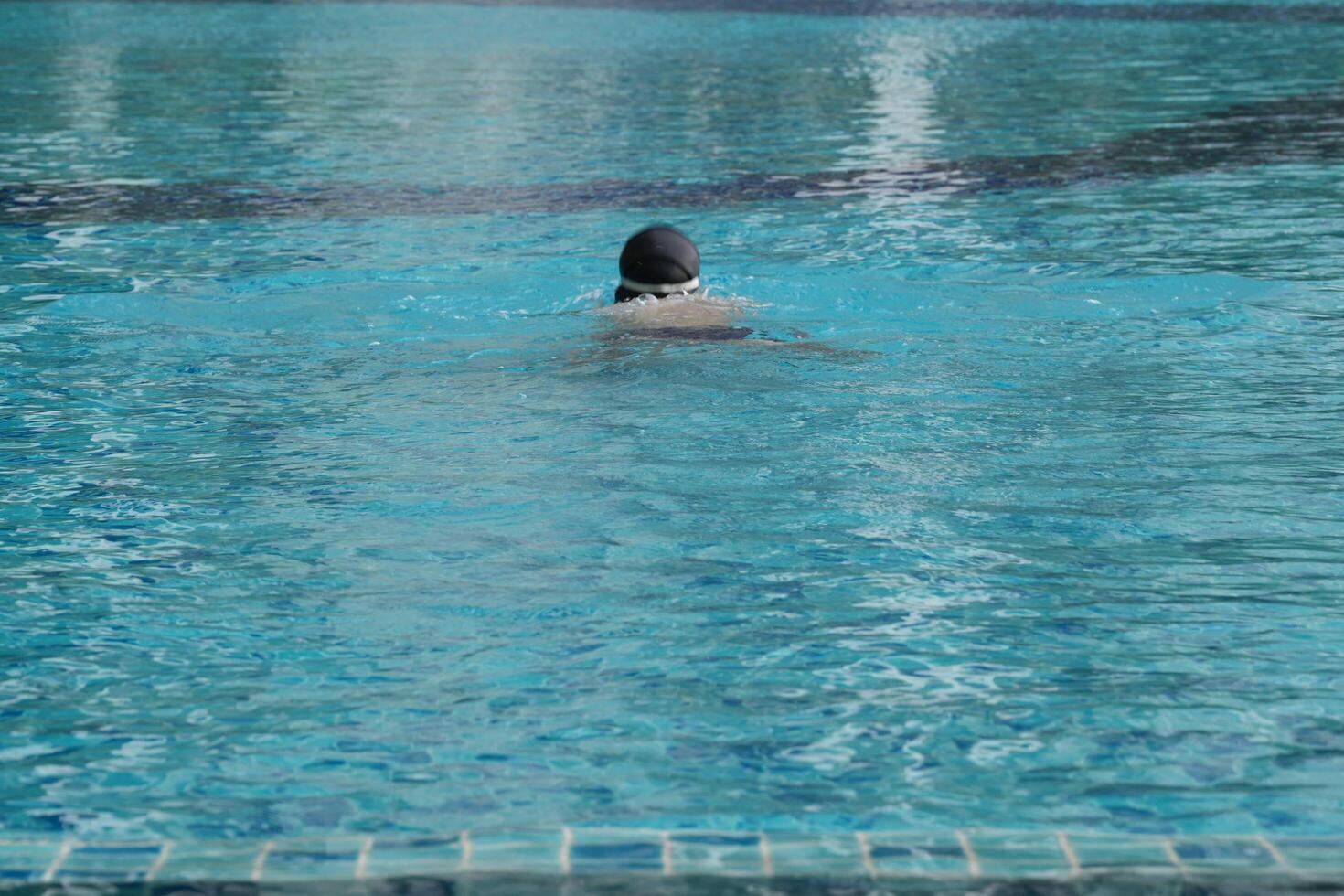 Asian men practicing swimming and preparing to play water polo and stretching and resting for water sports. photo
