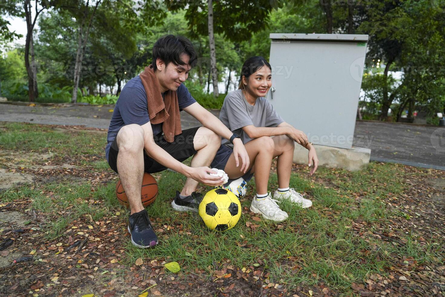 Male and female soccer players practice using the ball in the park field diligently and happily. photo