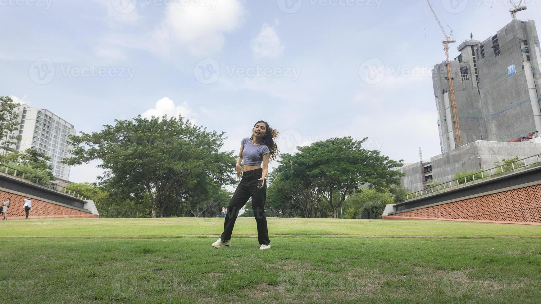 Asian women do freestyle hip hop and breakdancing in a public space in the middle of the city. With a cheerful and happy attitude photo