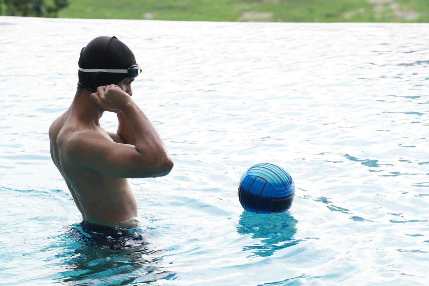Asian men practicing swimming and preparing to play water polo and stretching and resting for water sports. photo
