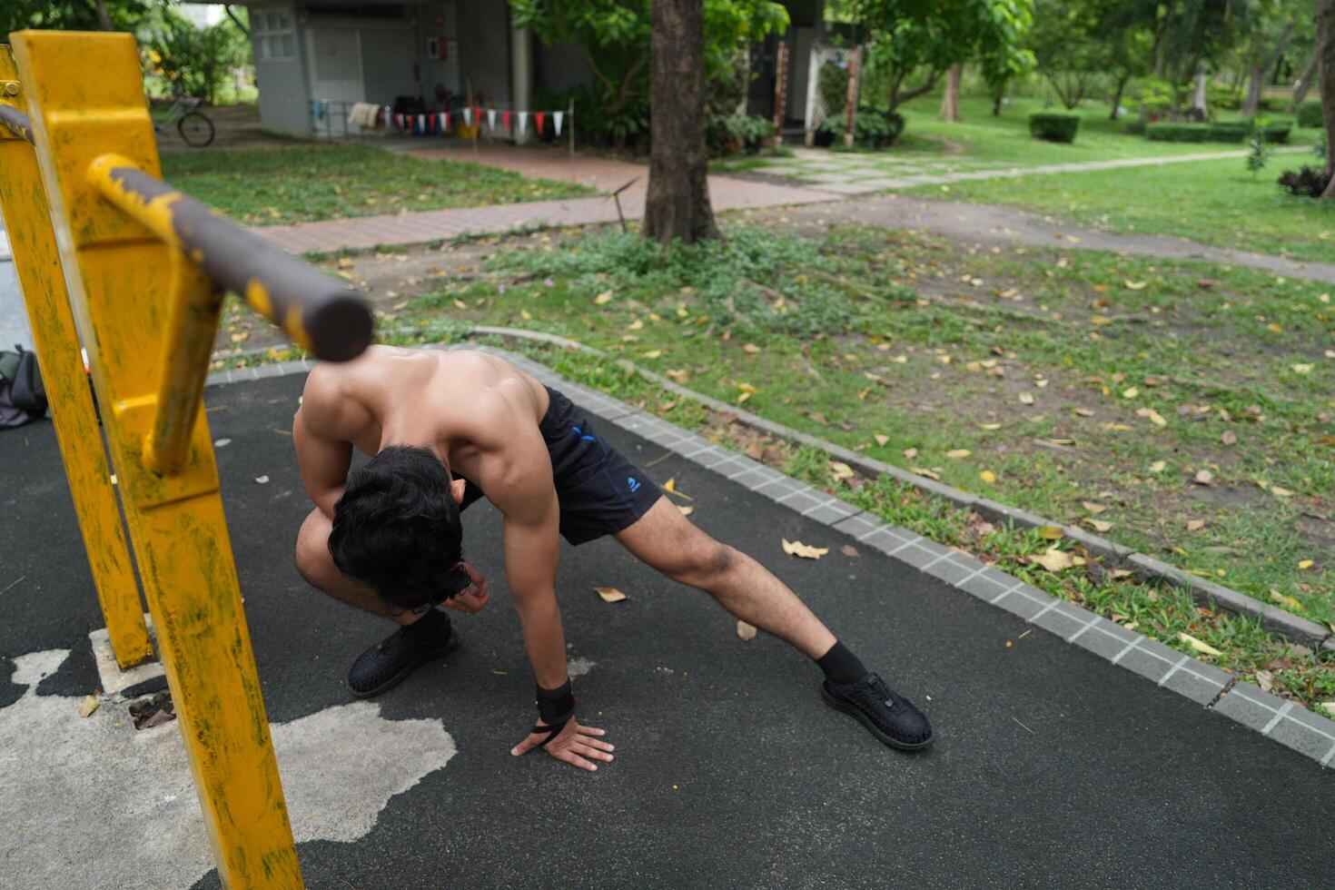 Asian man practicing gymnastics, doing gymnastics bar and hoop exercises and stretching, resting for sports. photo