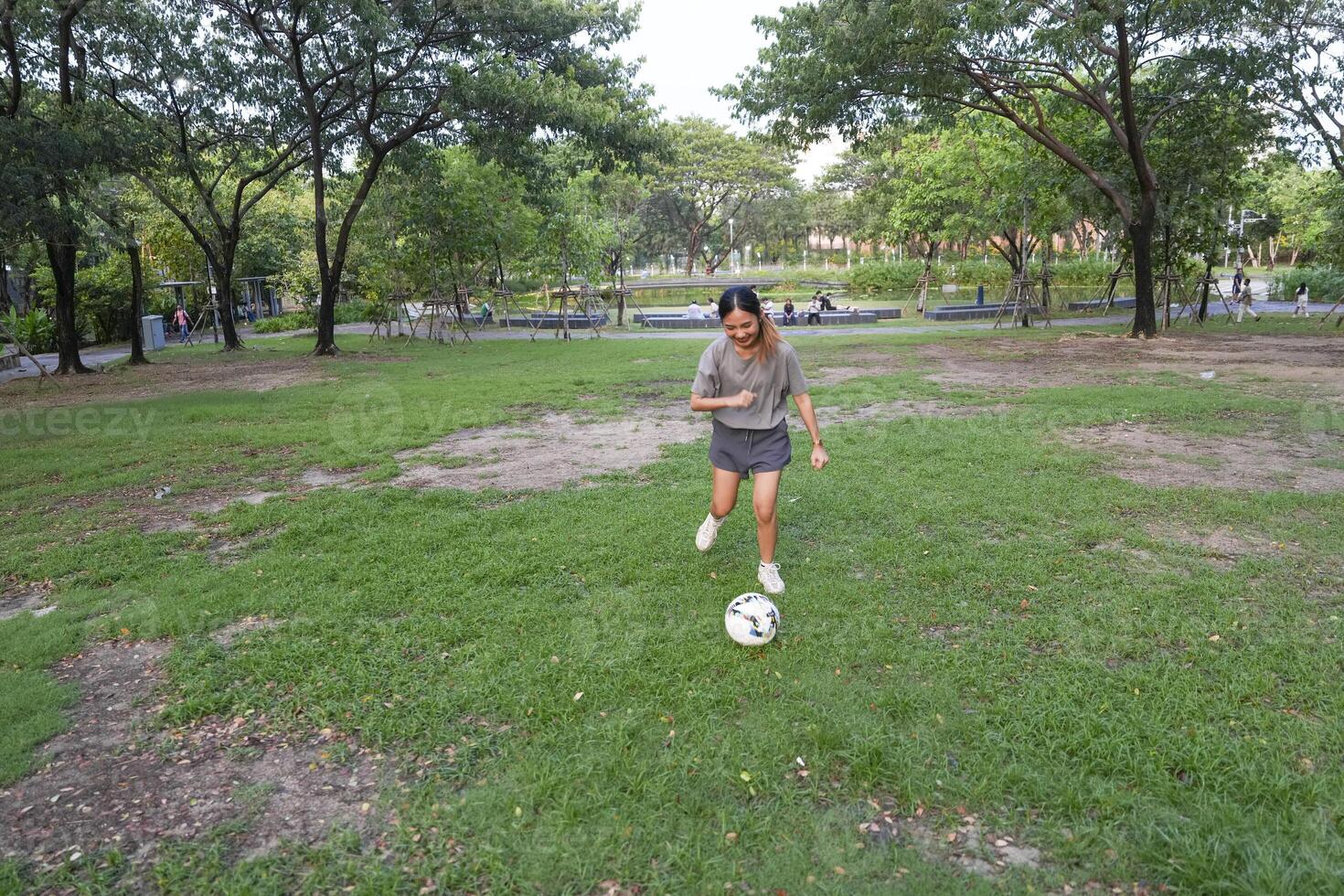 female soccer players practice using the ball in the park field diligently and happily. photo