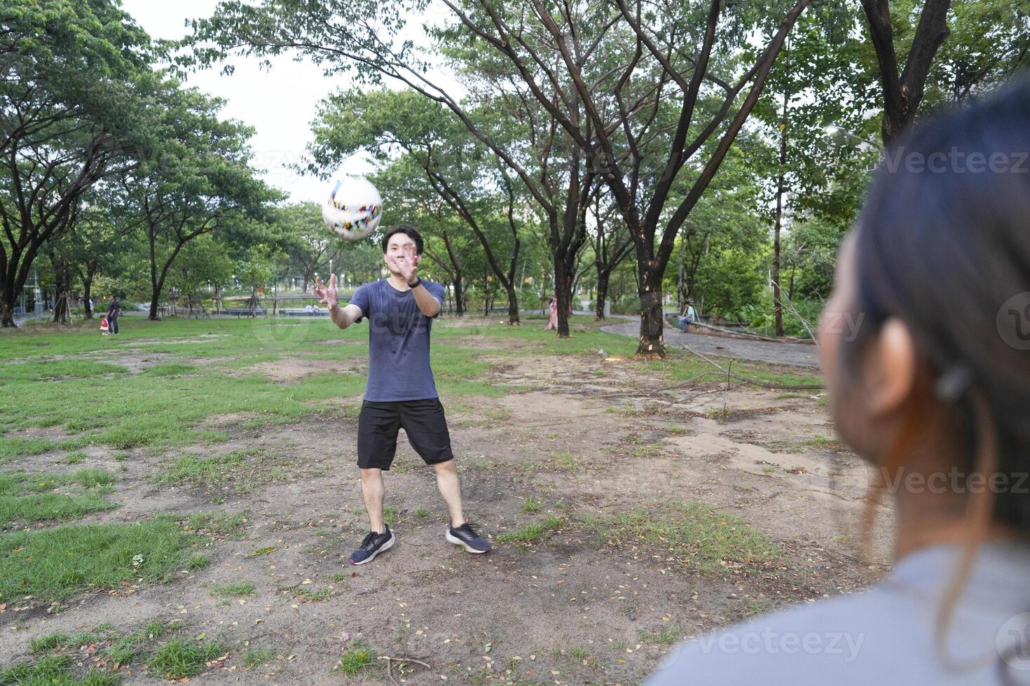 Male and female soccer players practice using the ball in the park field diligently and happily. photo