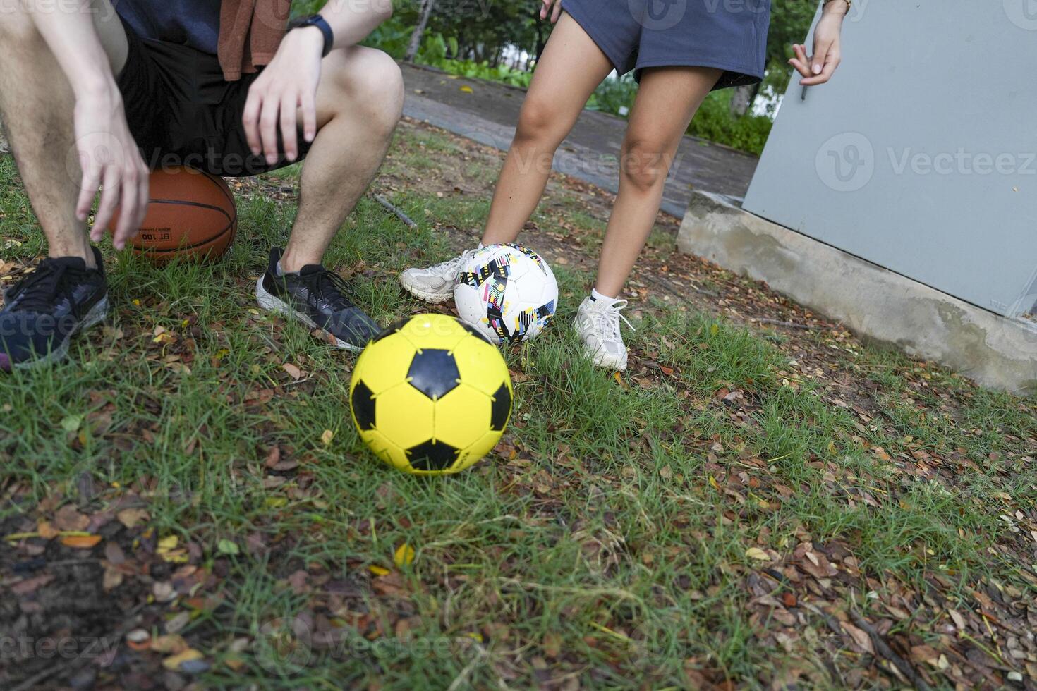 Male and female soccer players practice using the ball in the park field diligently and happily. photo