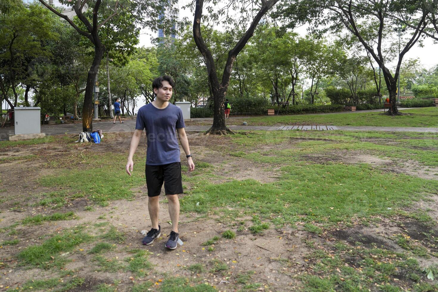 Male soccer players practice using the ball in the park field diligently and happily. photo