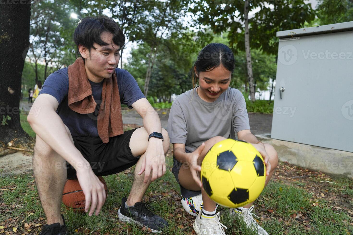 Male and female soccer players practice using the ball in the park field diligently and happily. photo