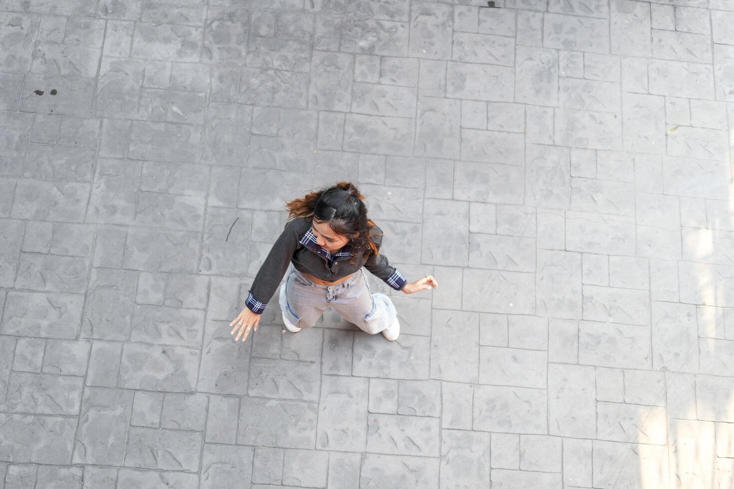 Asian women do freestyle hip hop and breakdancing in a public space in the middle of the city. With a cheerful and happy attitude photo