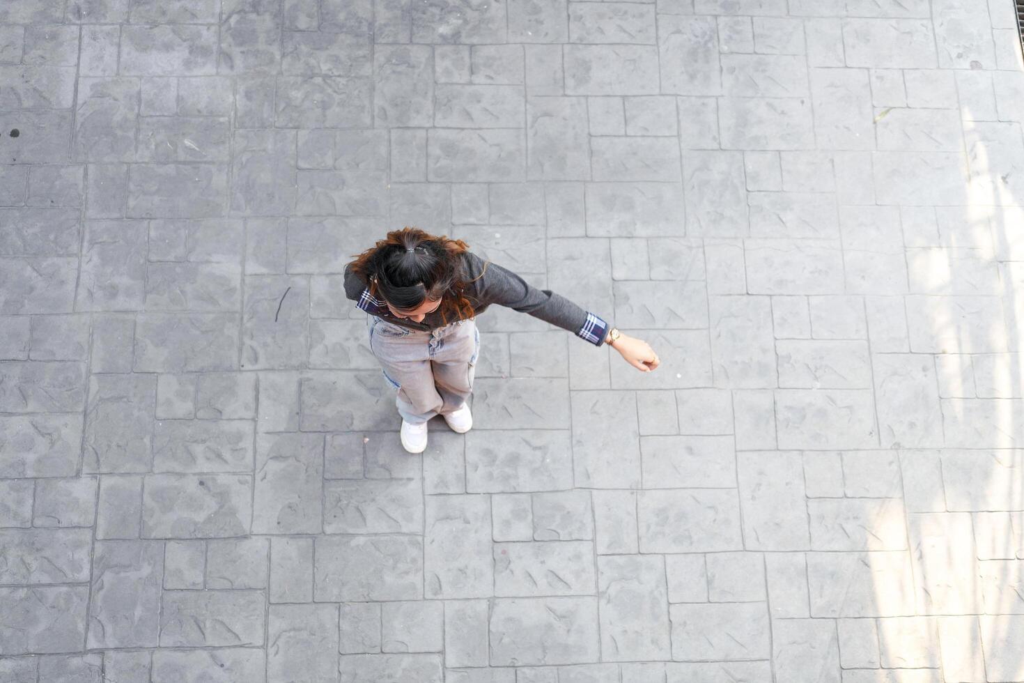 Asian women do freestyle hip hop and breakdancing in a public space in the middle of the city. With a cheerful and happy attitude photo