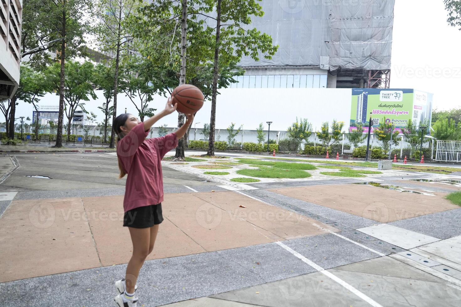 female basketball players practice using the ball in the park court diligently and happily. photo