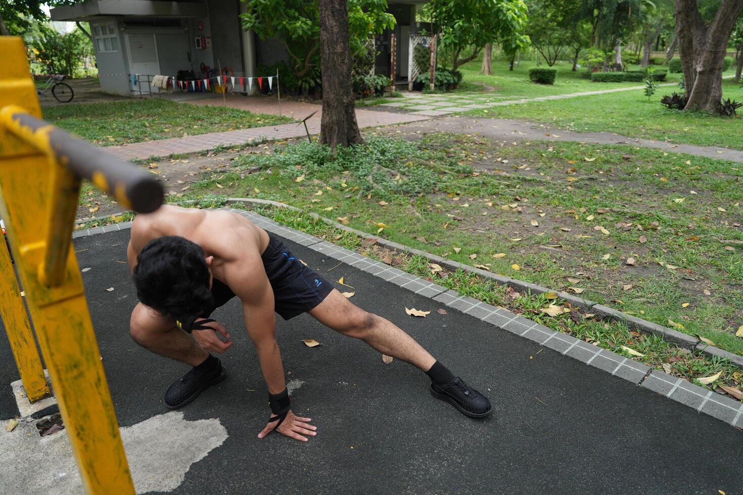 Asian man practicing gymnastics, doing gymnastics bar and hoop exercises and stretching, resting for sports. photo